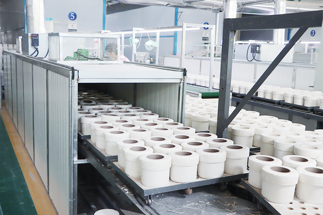 Professional ceramic mug production team working